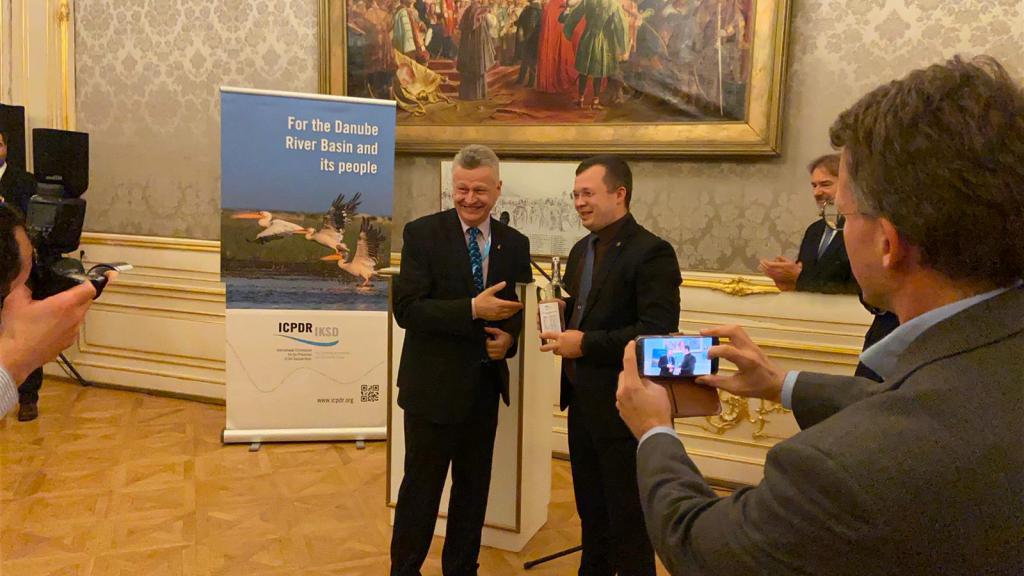 ICPDR President Dorin Andros poses with Danube bottle of water 