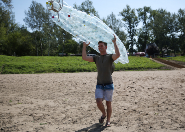 Man carries water bottle boat 