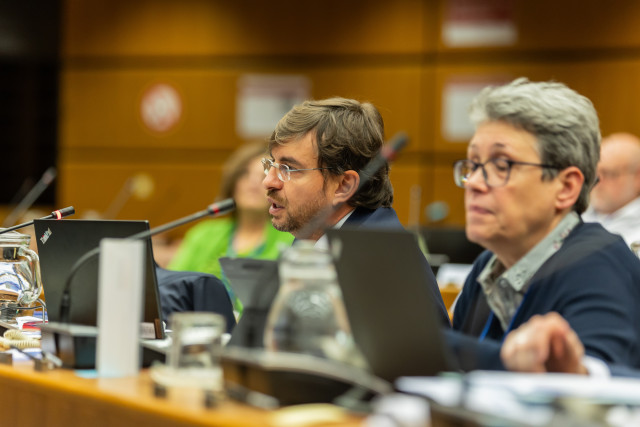 Man and woman sit in meeting